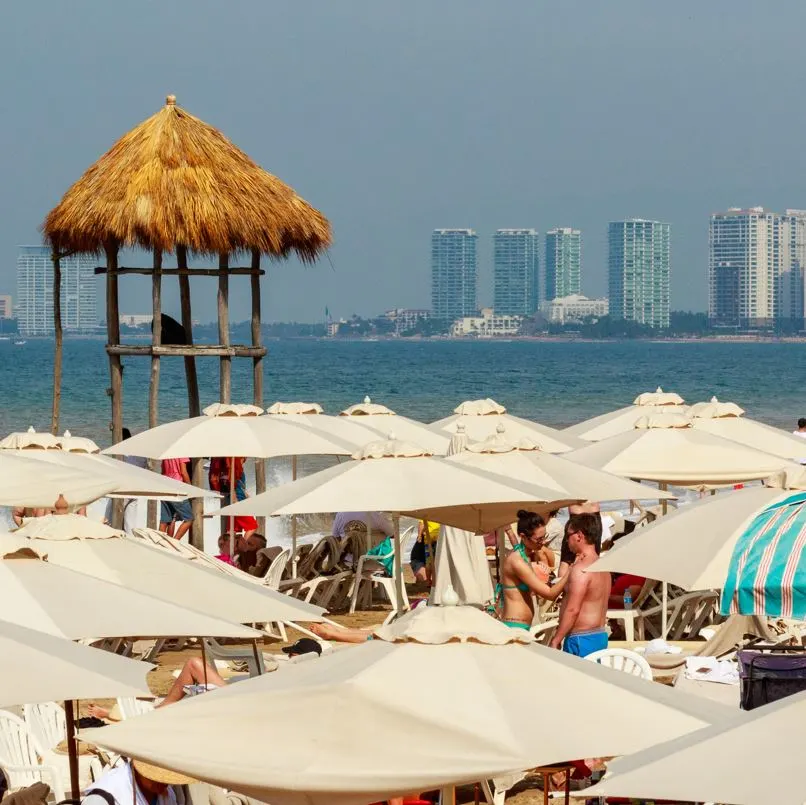 busy beach in puerto vallarta umbrellas