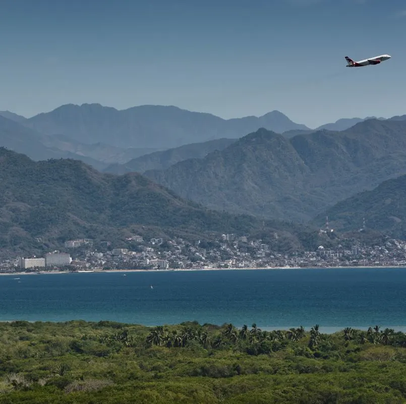 airplane over sierra madre mountains in bahia de banderas