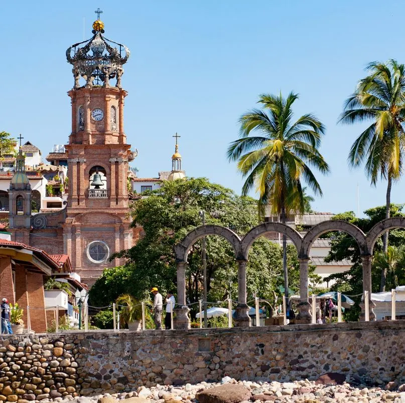 iglesia de guadalupe with palm trees and los arcos