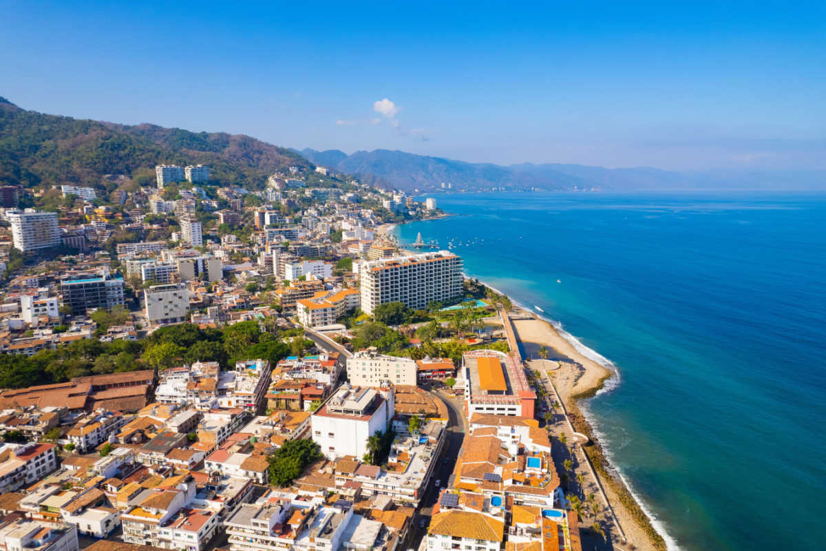 Aerial view of the downtown area in puerto vallarta with a beach 