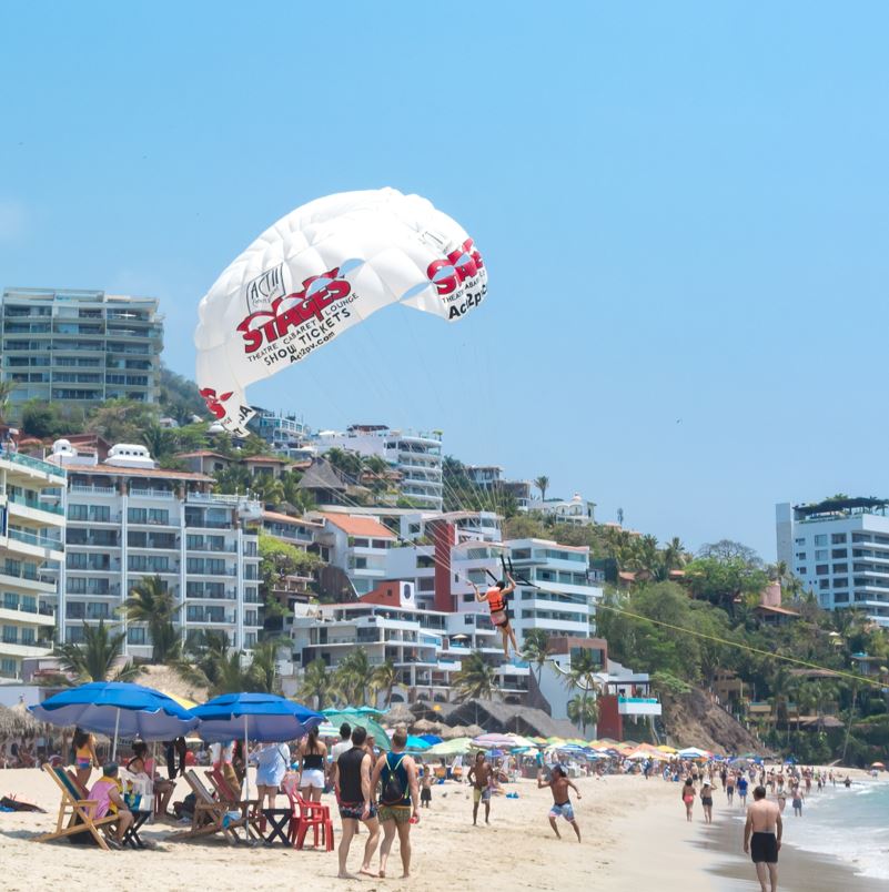 busy beach in puerto vallarta with water sports