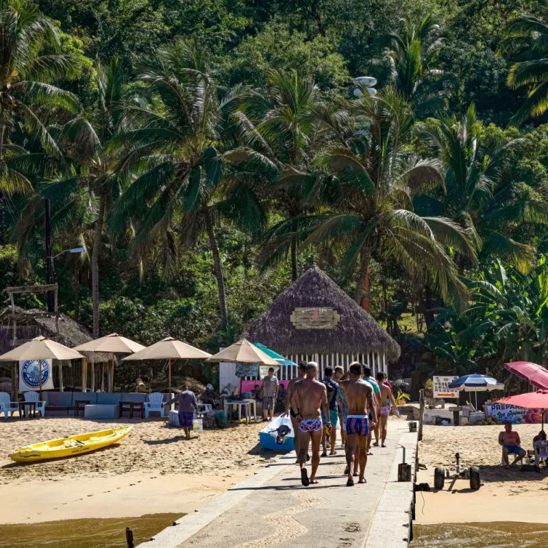 A group of men enter the beachfront town of Las Animas, located just south of Puerto Vallarta