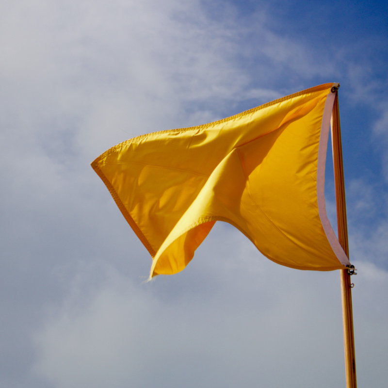 Yellow flag waving in the wind