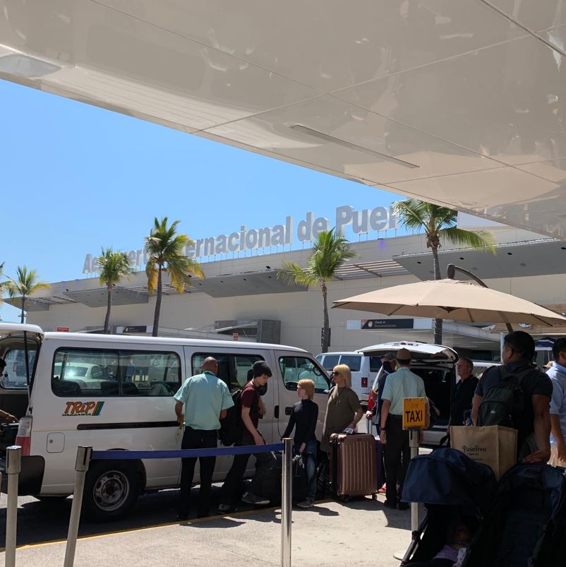 puerto vallarta airport busy with travelers waiting for taxis